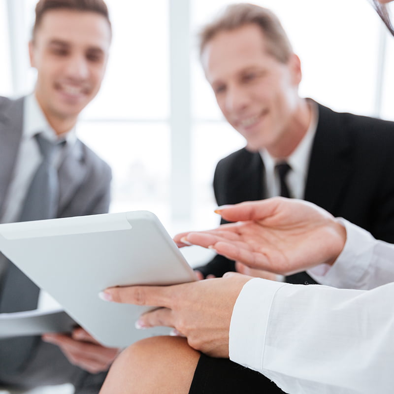 Cropped image of three business people with tablet